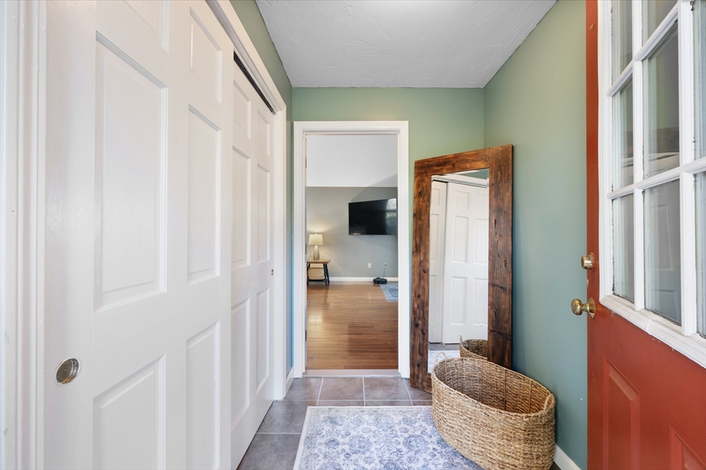 42 Breakneck Road Sturbridge, MA 01566 - Photo 8 of 35 a hallway with two windows and a livingroom
