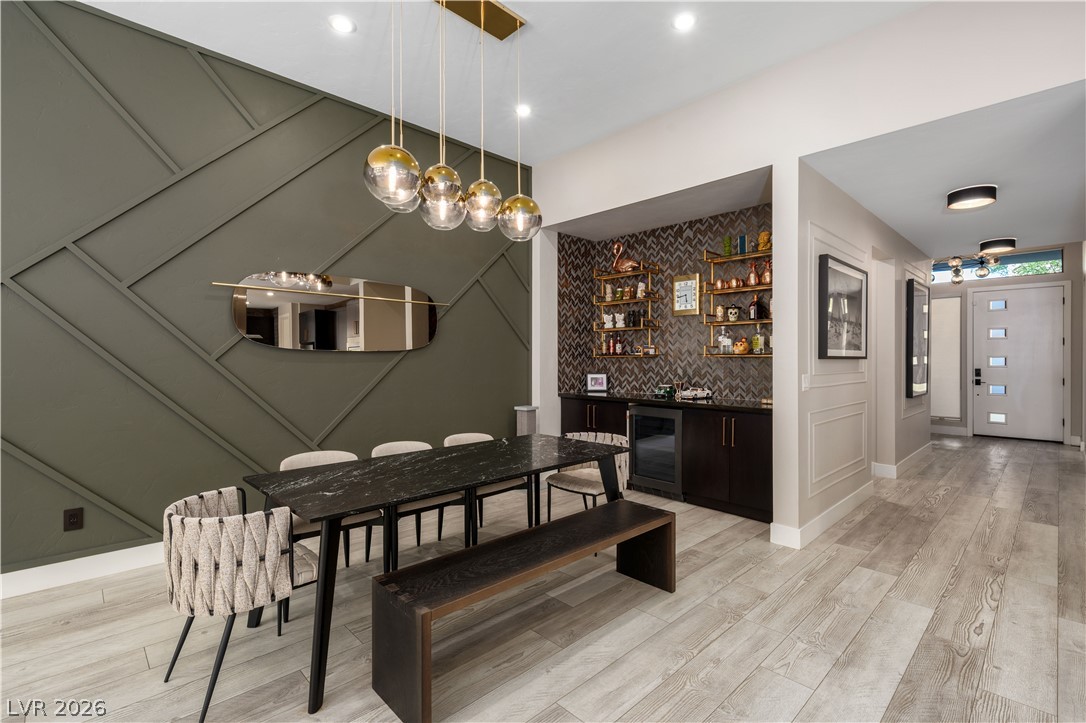 9719 Starlight Ridge Avenue Las Vegas, NV 89148 - Photo 6 of 25 A chic dining area with unique wall molding leads to a convenient wet bar and elegant entryway.