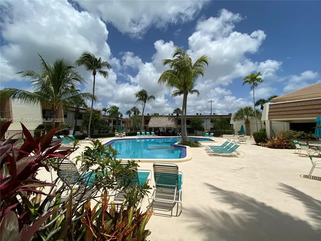 a view of a house with a yard and sitting area