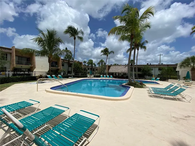 a view of a swimming pool and lounge chairs