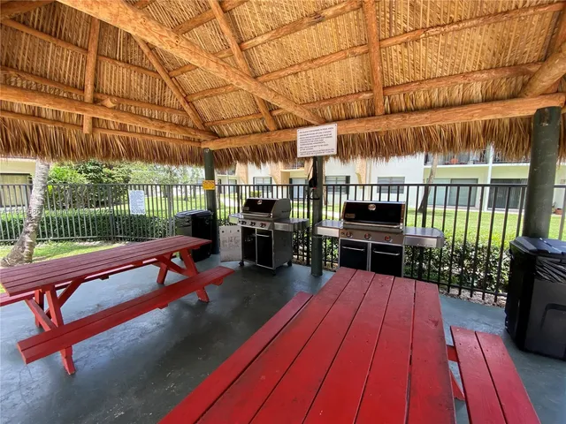 a view of a patio with a table and chairs