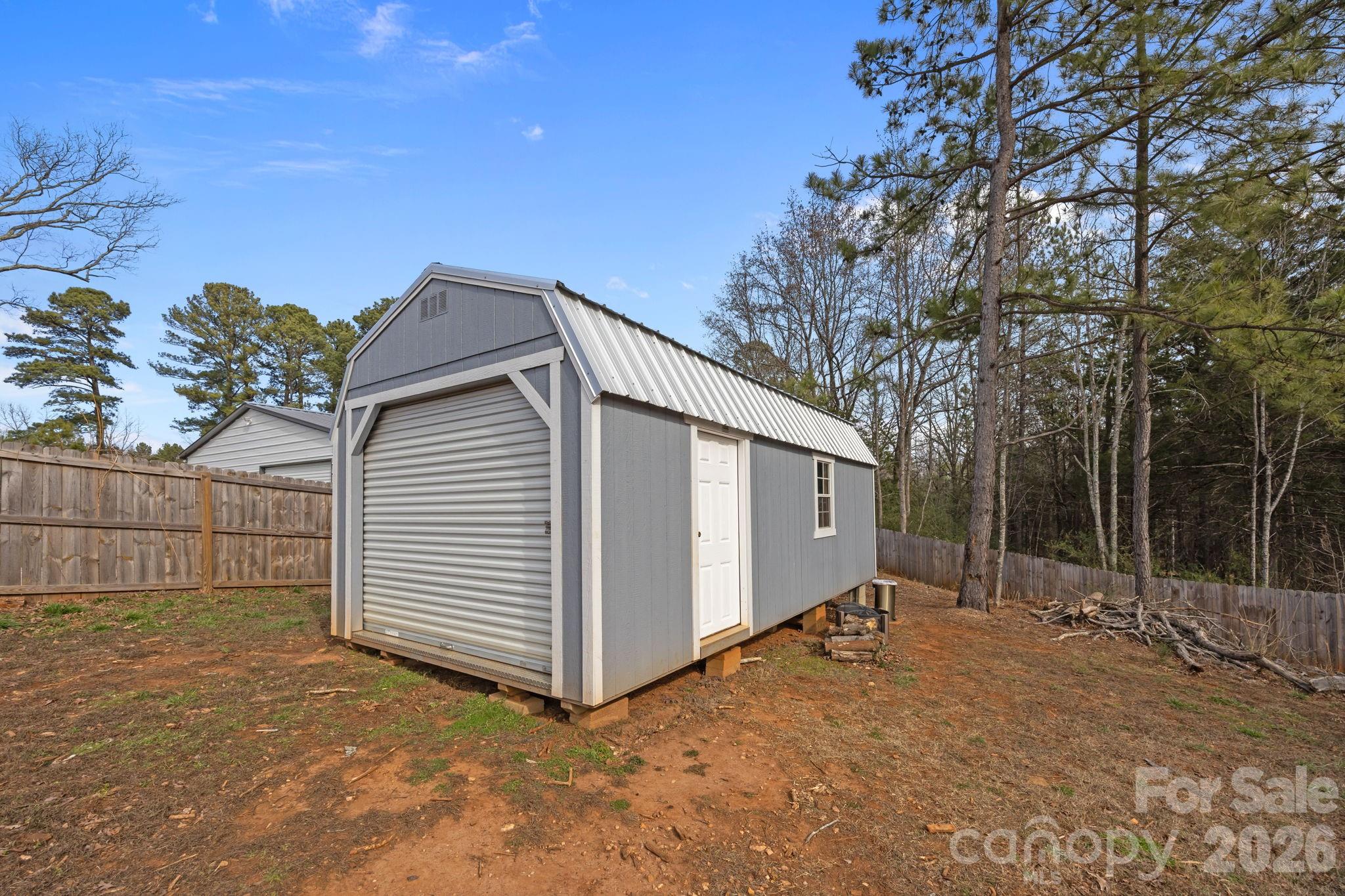 1464 State Rd S-46-996 York, SC 29745 - Photo 13 of 17 a view of a house with a backyard and garage