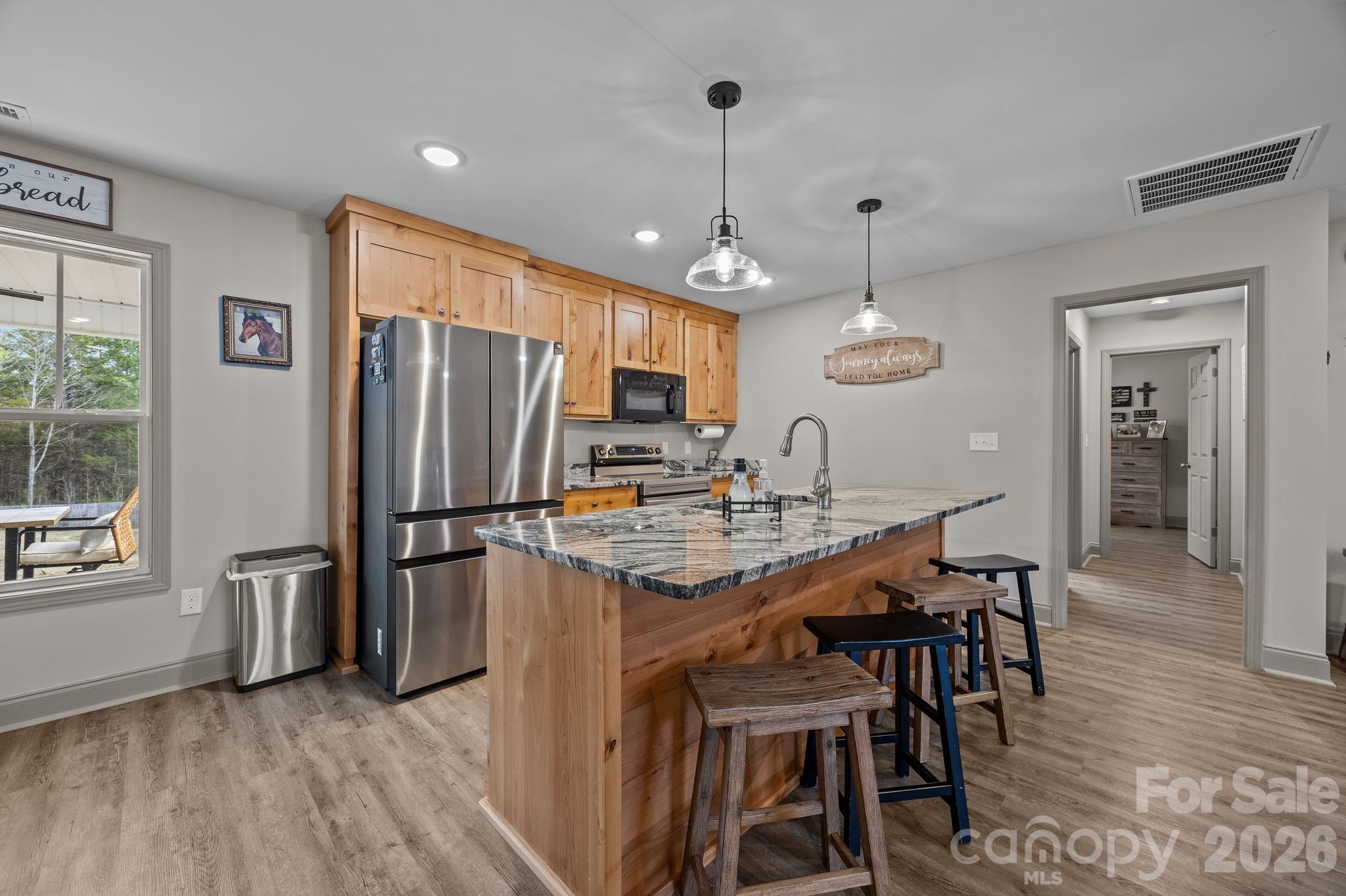 1464 State Rd S-46-996 York, SC 29745 - Photo 2 of 17 a kitchen with stainless steel appliances a dining table chairs refrigerator and sink