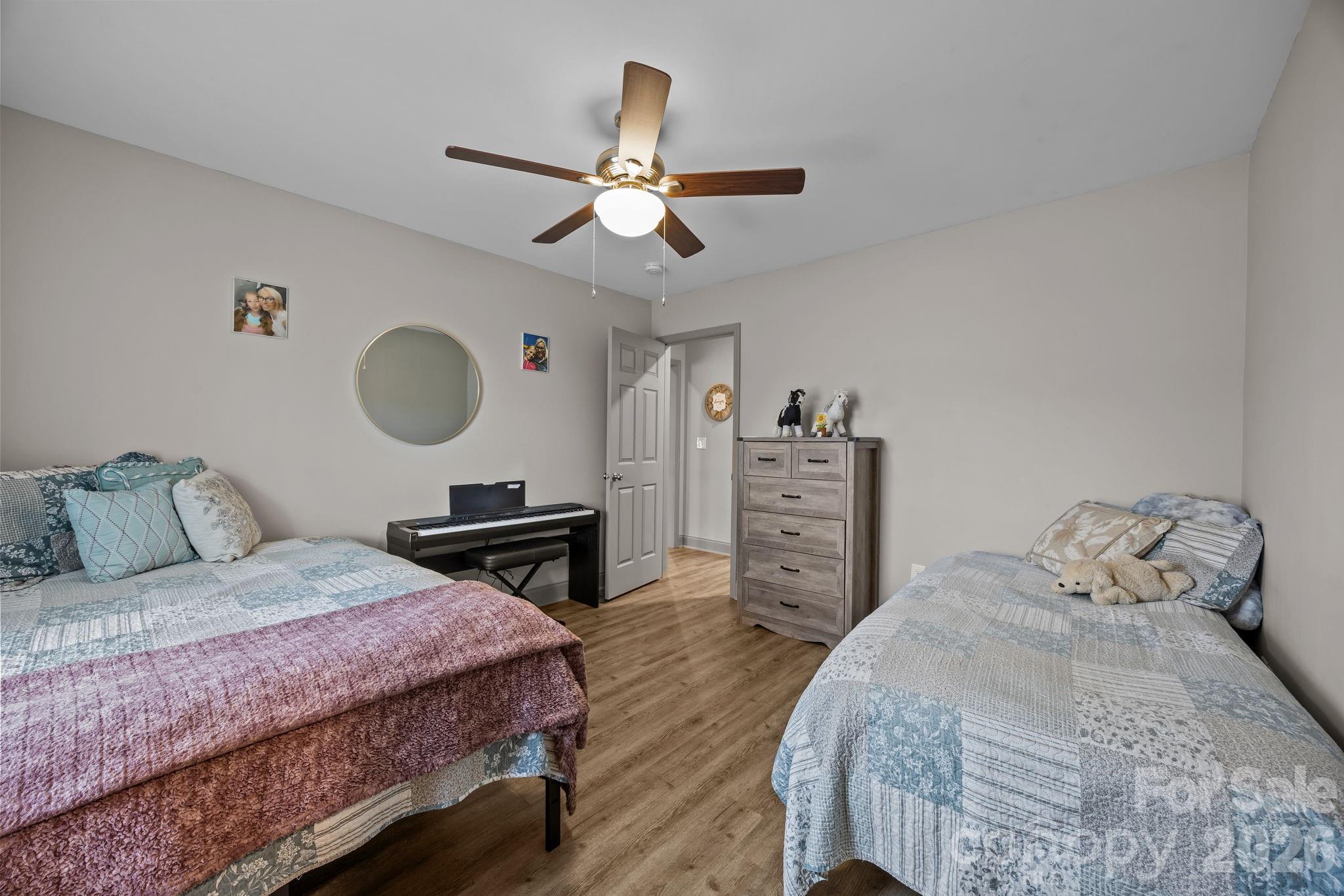 1464 State Rd S-46-996 York, SC 29745 - Photo 9 of 17 a bedroom with a bed and a chandelier