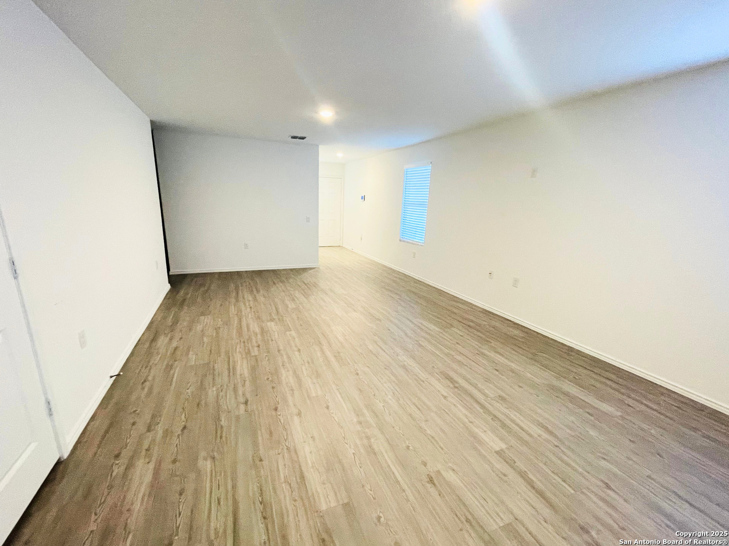 13307 Dutra Road San Antonio, TX 78221 - Photo 7 of 33 an empty room with wooden floor