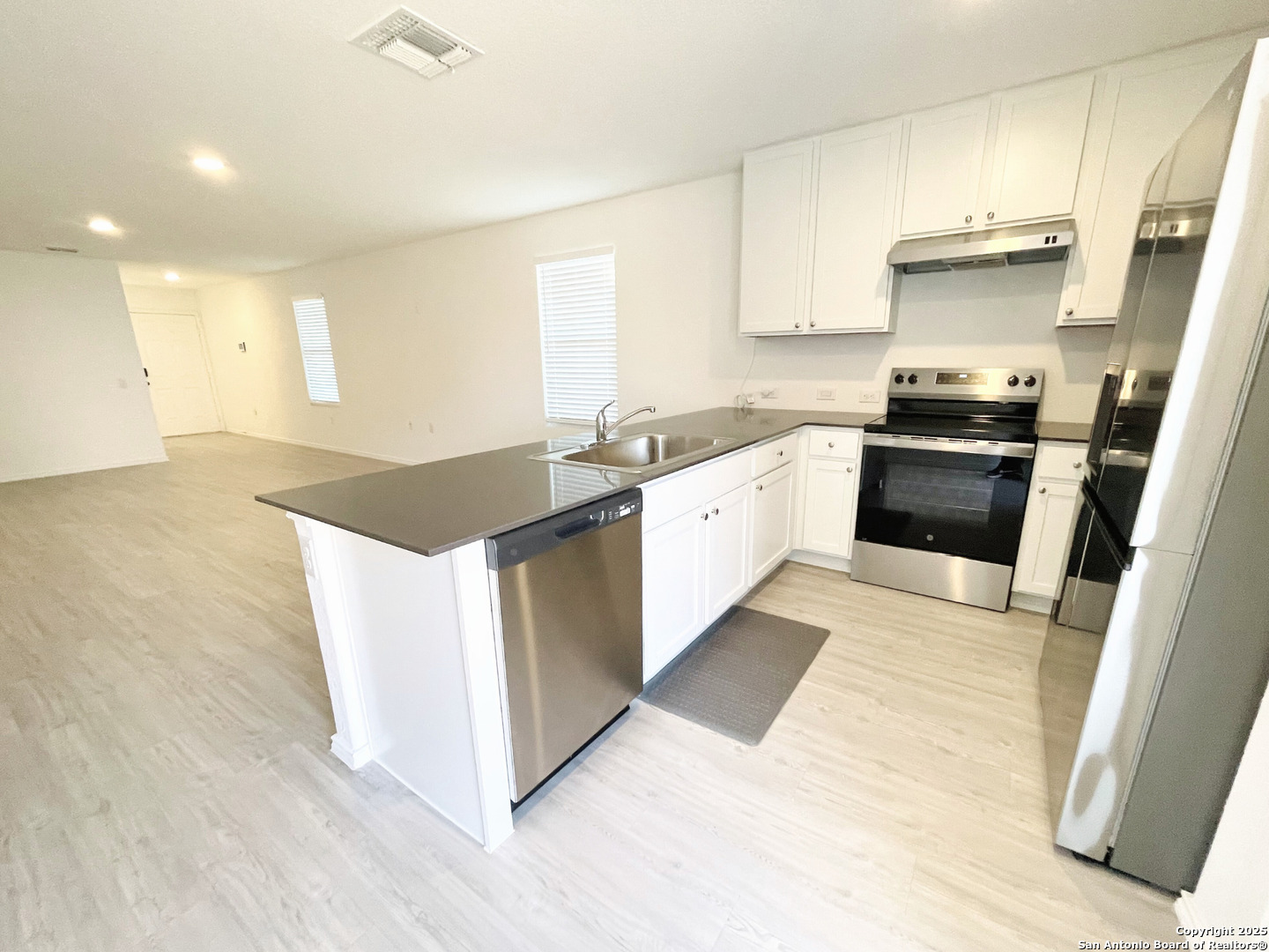 13307 Dutra Road San Antonio, TX 78221 - Photo 8 of 33 a kitchen with granite countertop a stove and a sink
