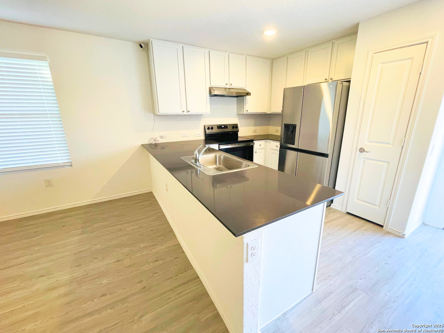 13307 Dutra Road San Antonio, TX 78221 - Photo 10 of 33 a kitchen with kitchen island a counter top space a refrigerator a sink and cabinets