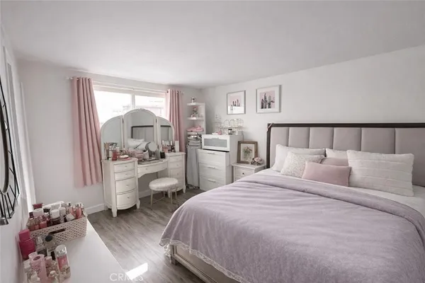 a bedroom with a bed and a view of kitchen