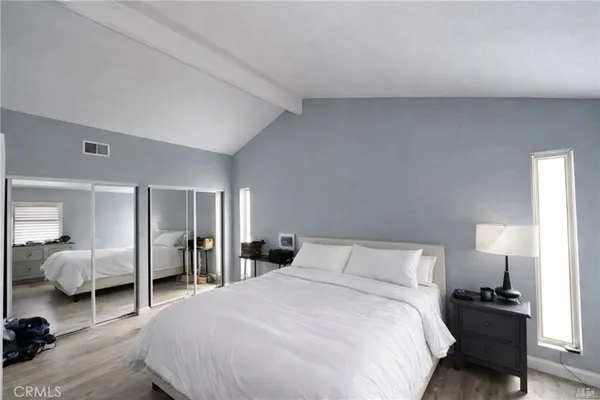 a bedroom with a bed and walk in closet