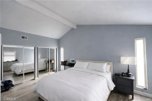 a bedroom with a bed and walk in closet