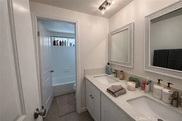 a bathroom with a granite countertop sink mirror and vanity