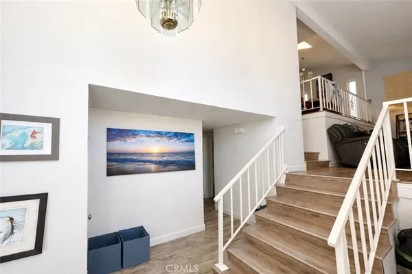 a view of a livingroom with wooden floor and stairs
