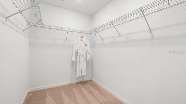 a bathroom with a toilet a sink and glass door