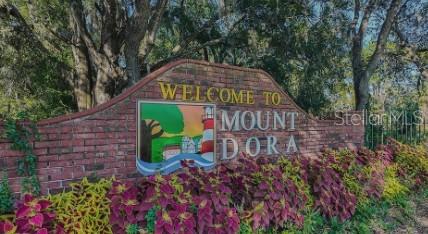 707 Perth Drive, Unit 2 Mount Dora, FL 32757 - Photo 20 of 21 a view of a sign in a garden