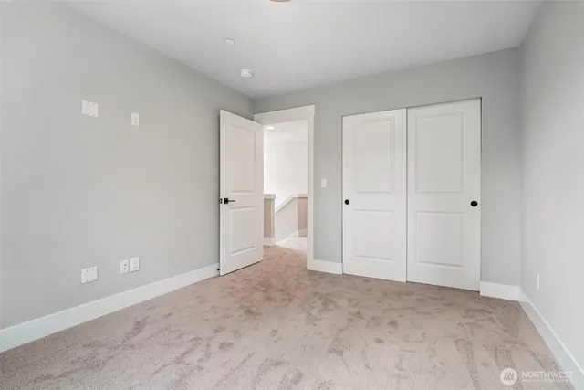 a bathroom with a granite countertop sink a toilet and a mirror