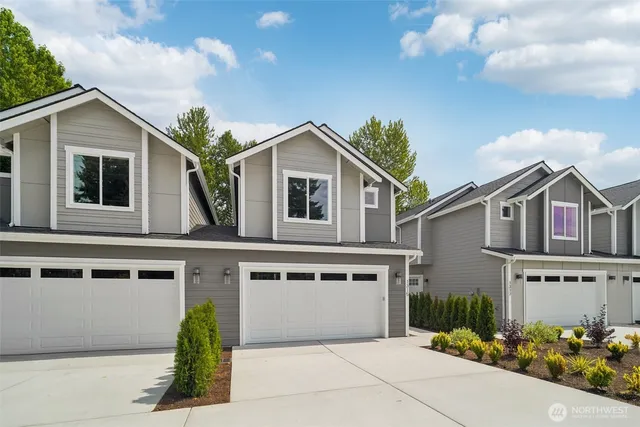 a backyard of a house with yard table and chairs