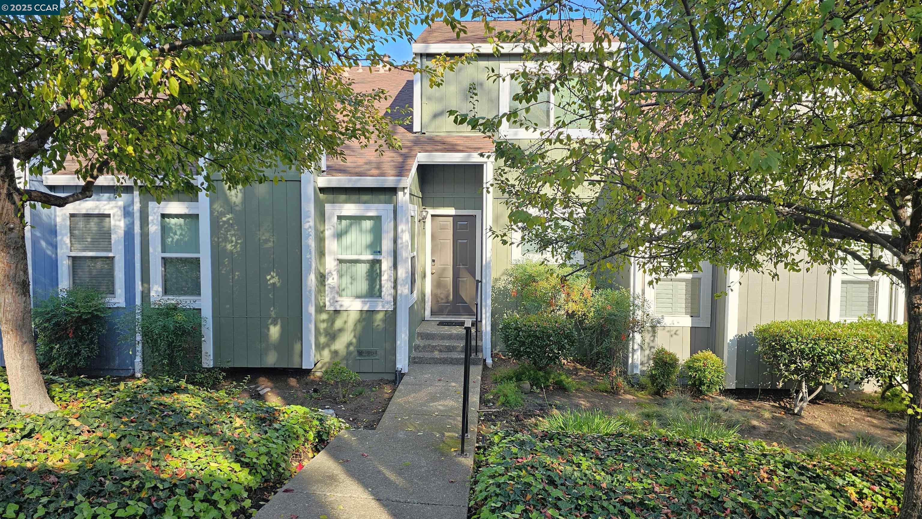a front view of a house with a yard