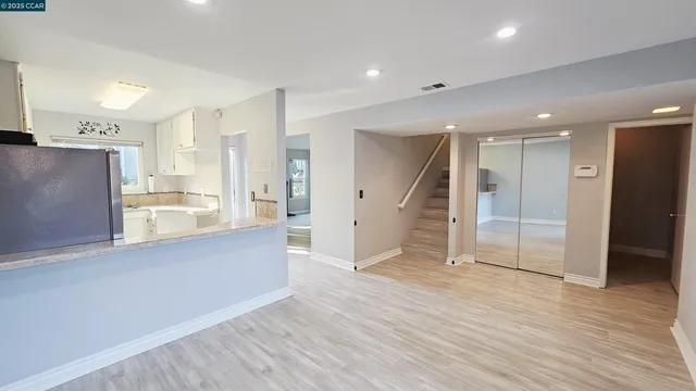 a view of a kitchen with wooden floor and a window