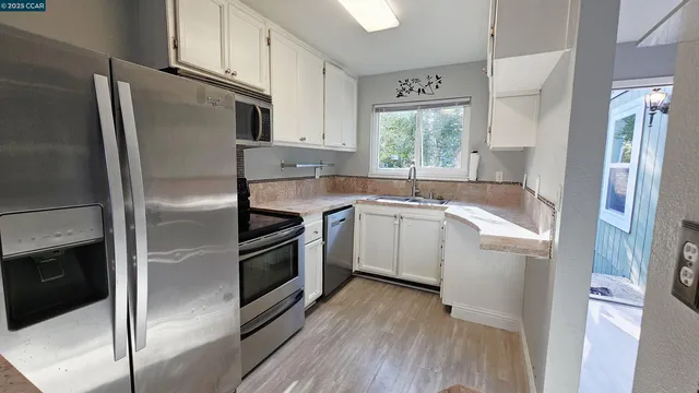 a kitchen with a refrigerator sink and stove