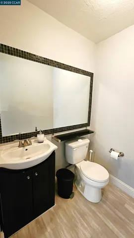 a bathroom with a sink mirror vanity and toilet