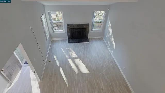 a view of entryway and kitchen with wooden floor