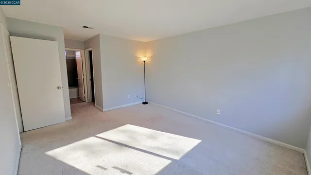 a view of a hallway to rooms