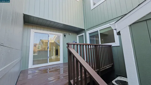 a view of a house with a small yard and garage