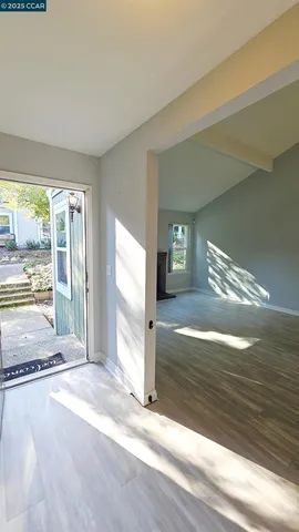 a view of a room with wooden floor and window