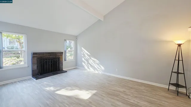 wooden floor in an empty room with a fireplace