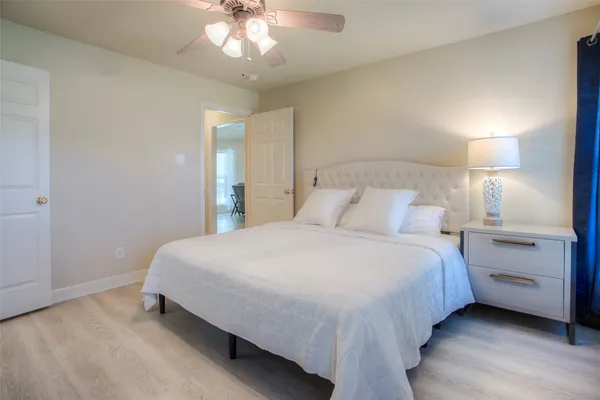 a bedroom with a bed and a night stand