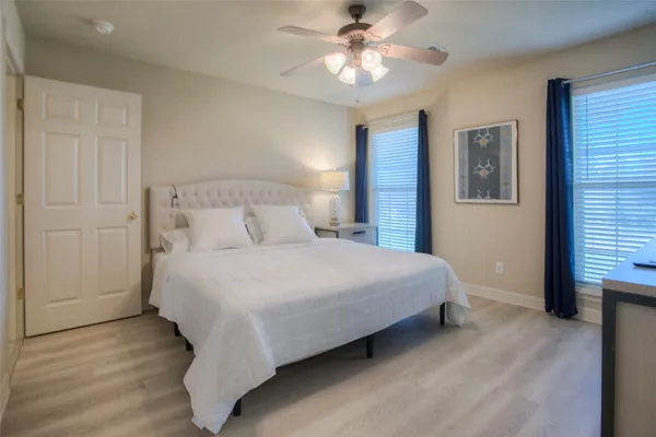 a bedroom with a bed and a ceiling fan