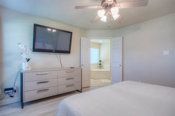 a bedroom with a bed and a flat screen tv