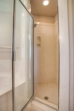 a bathroom with a glass shower door