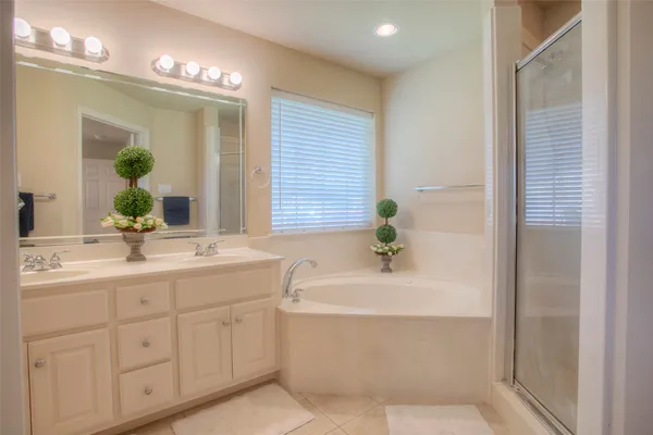 a bathroom with a bathtub a sink and a window