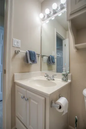 a bathroom with a sink vanity and a mirror