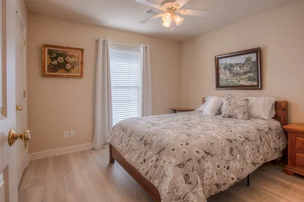 a bedroom with bed and painting on the wall
