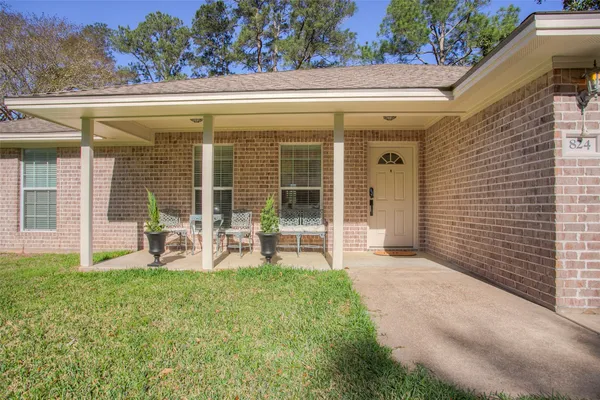 a front view of a house with garden and porch