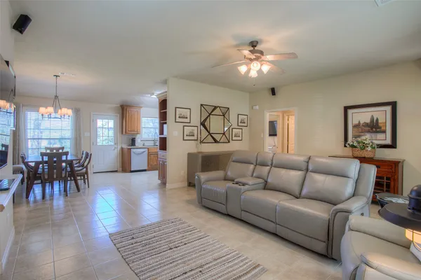 a living room with furniture and a chandelier