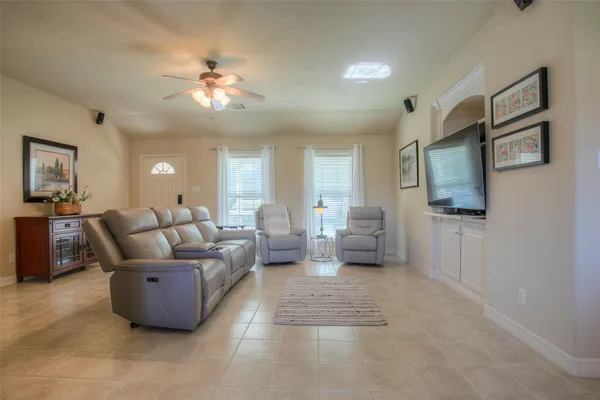a living room with furniture and a chandelier