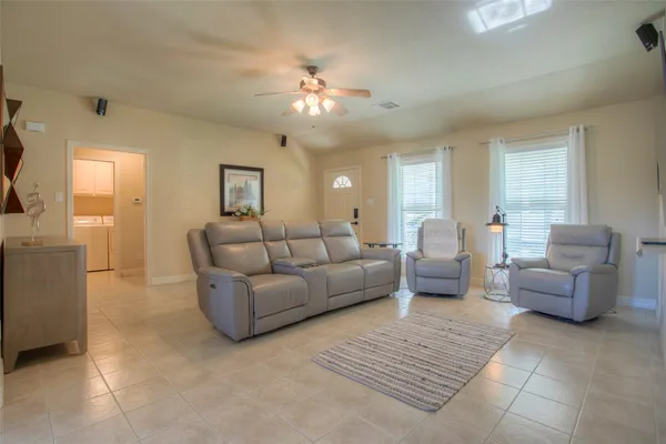 a living room with furniture and a chandelier