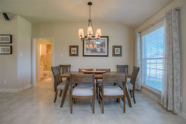 a view of a dining room with furniture and window