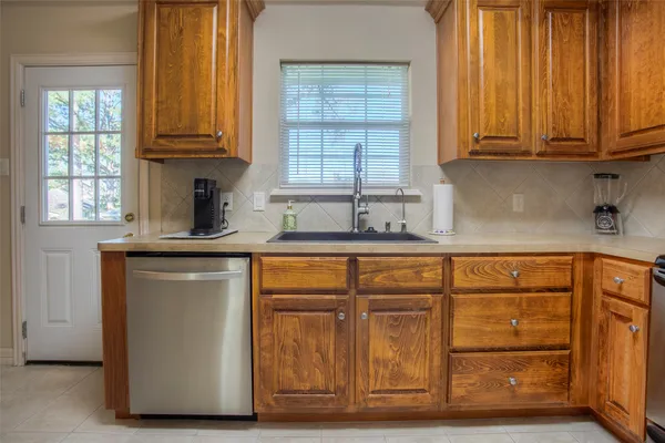 a kitchen with wooden cabinets and a sink