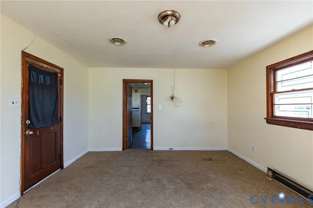 an empty room with closet and windows