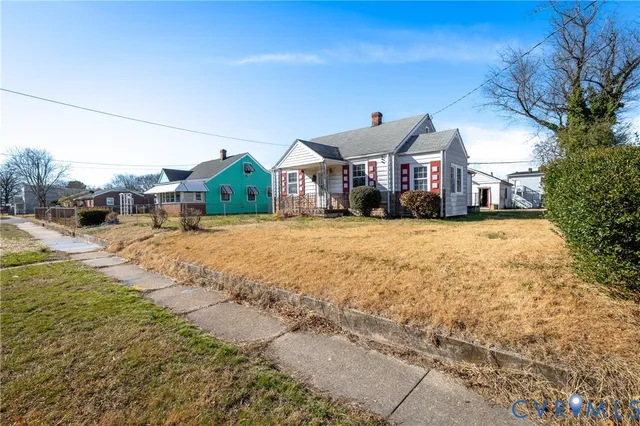 a view of a house with a yard and garage