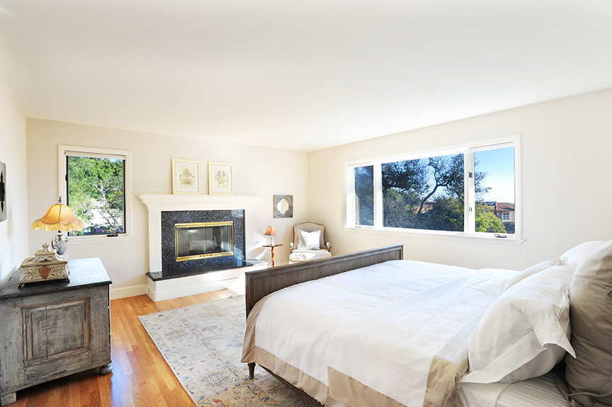 1736 Lasuen Road Santa Barbara, CA 93103 - Photo 10 of 17 a bedroom with a bed and a fireplace