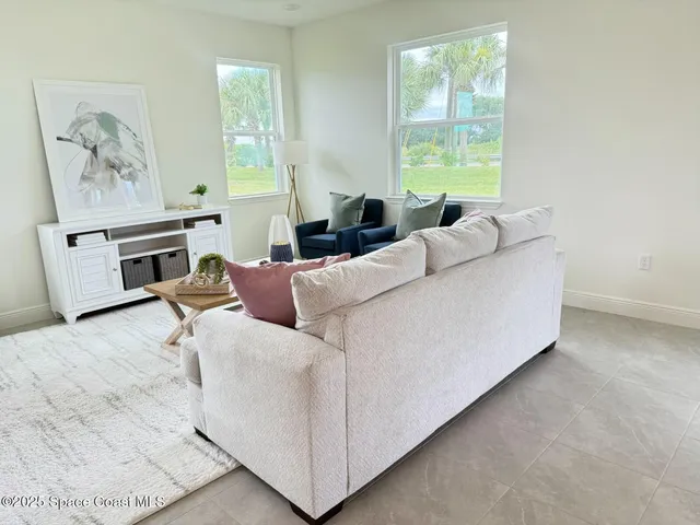a living room with furniture and a window