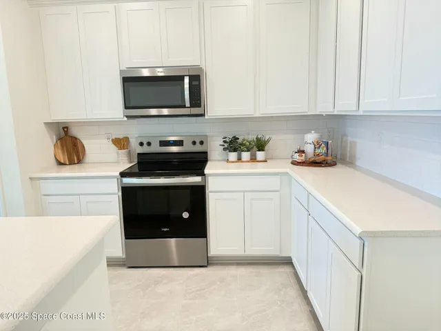 a kitchen with a stove and a microwave