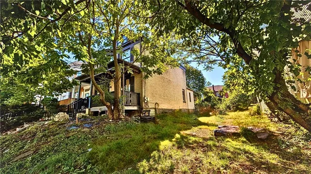 a view of outdoor space with deck and tree