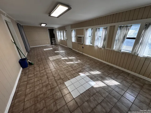 a bed sitting in a room next to a window