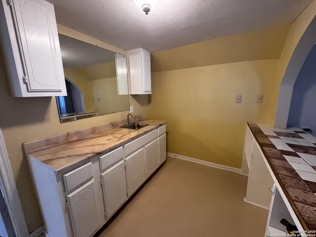 a utility room with sink dryer and washer